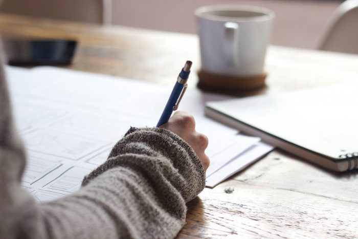 woman taking an exam to earn college credit